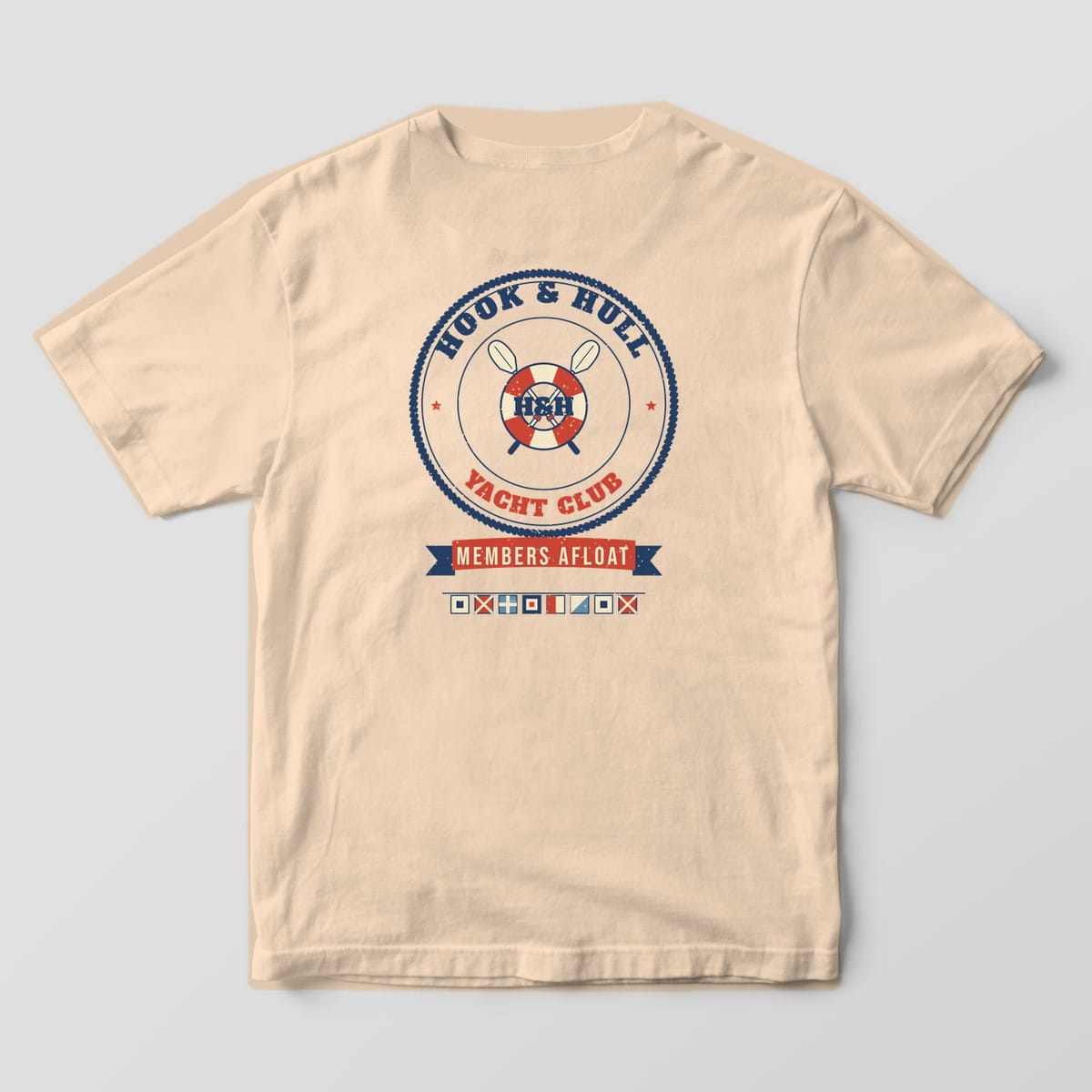 Back of an ivory Comfort Colors 1717 T-shirt showing the rope ring crest with a red and cream life ring, crossed oars and the words Hook and Hull Yacht Club, Members Afloat