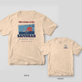 Back and front of an ivory Comfort Colors T-shirt with a vintage postcard of boats anchored at a sandbar at sunset with the words Life is better at the Sandbar; small chest print on the front