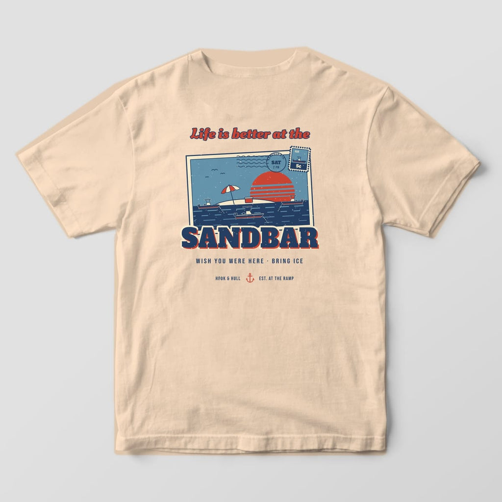 Back of an ivory Comfort Colors 1717 T-shirt showing a vintage postcard of boats anchored at a sandbar at sunset with the words Life is better at the Sandbar