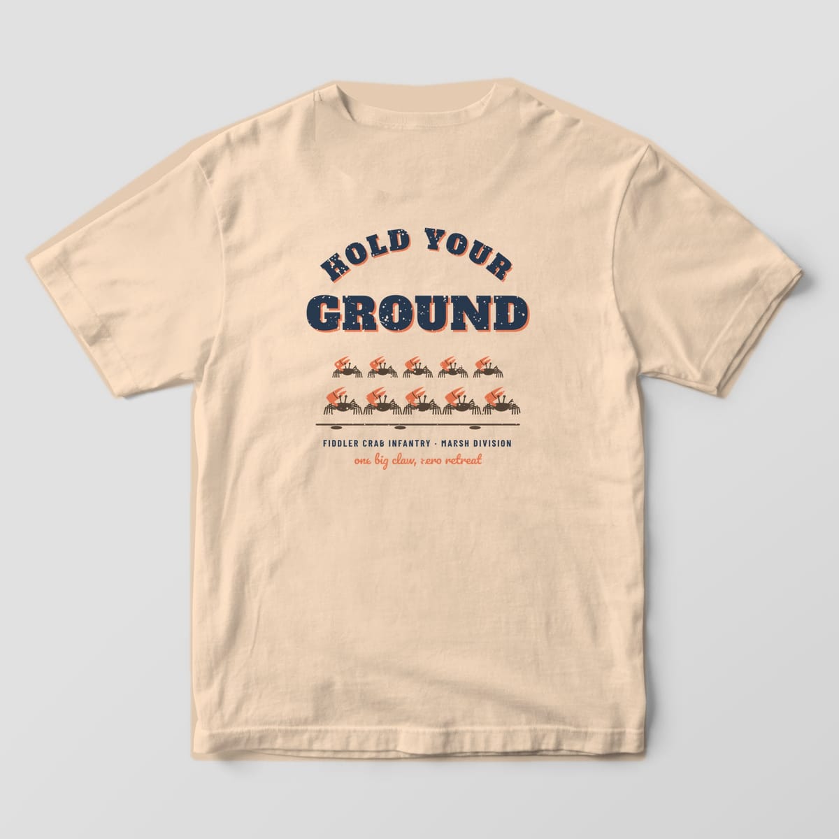 Back of an ivory Comfort Colors 1717 tee with navy and coral Hold Your Ground lettering over ten fiddler crabs