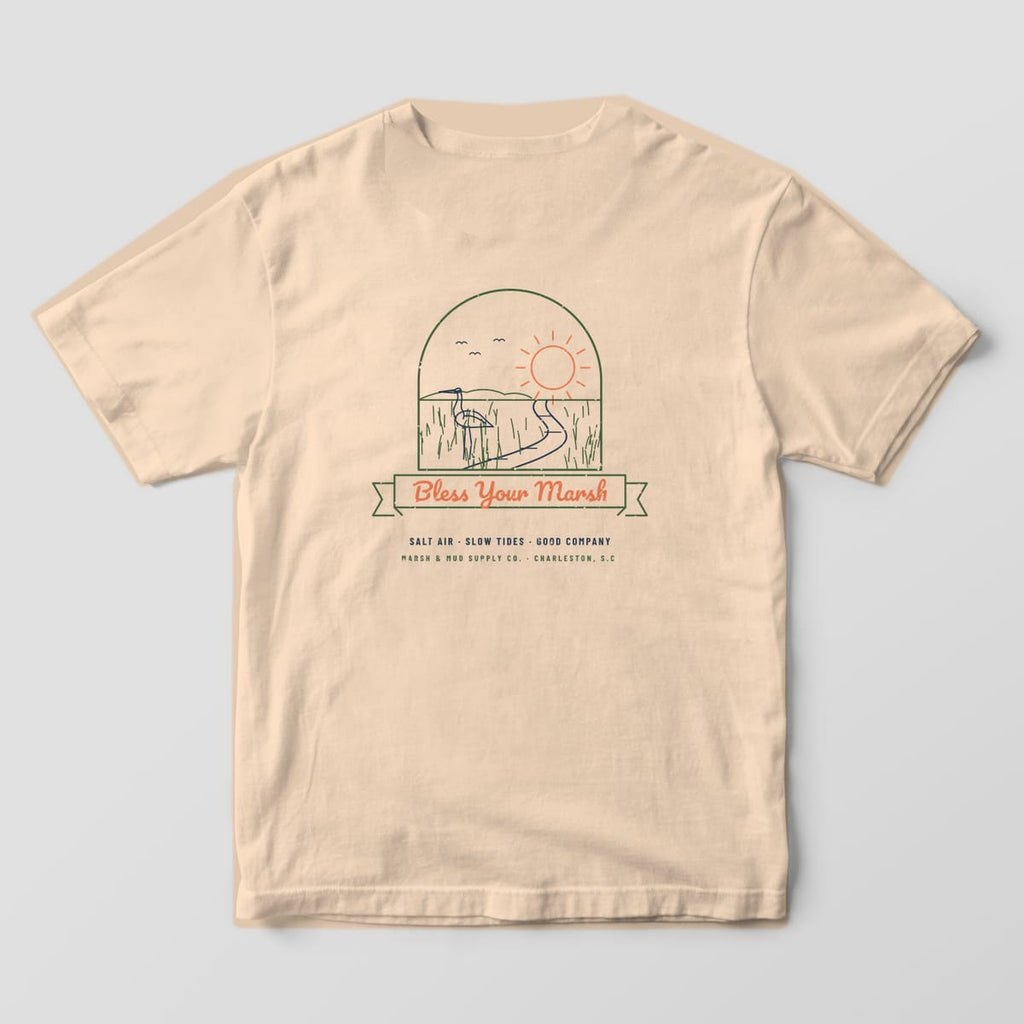 Back of an ivory Comfort Colors 1717 tee with a line-art marsh scene, egret and sunset inside an arch