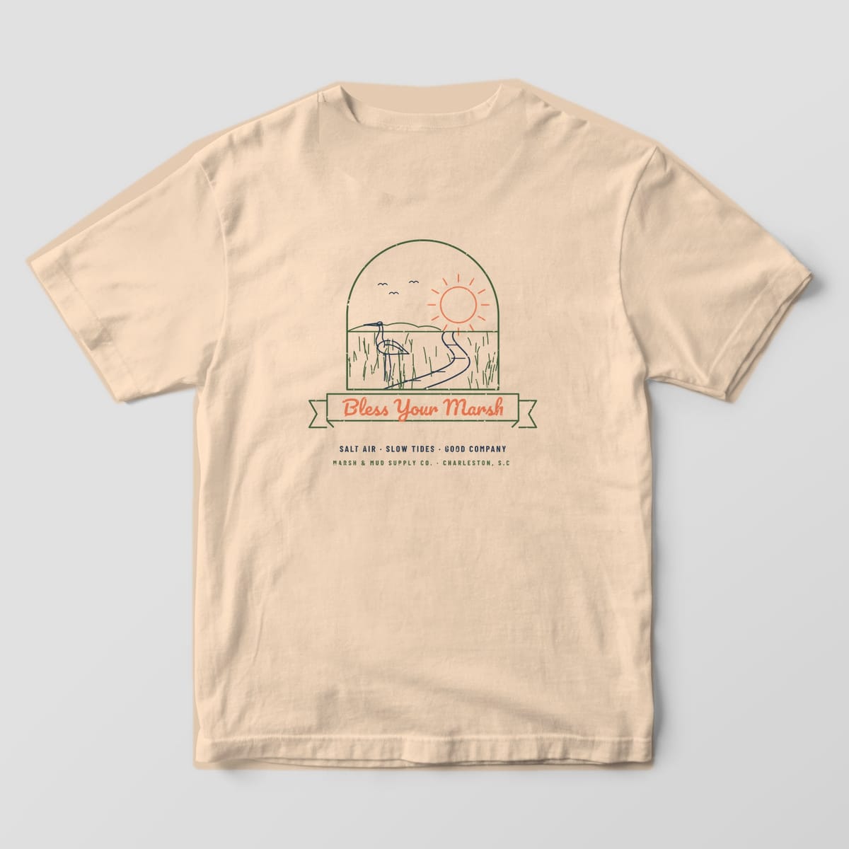 Back of an ivory Comfort Colors 1717 tee with a line-art marsh scene, egret and sunset inside an arch