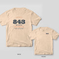 Back and front of an ivory Comfort Colors tee with oyster-shell-filled 843 numerals and Not an 854