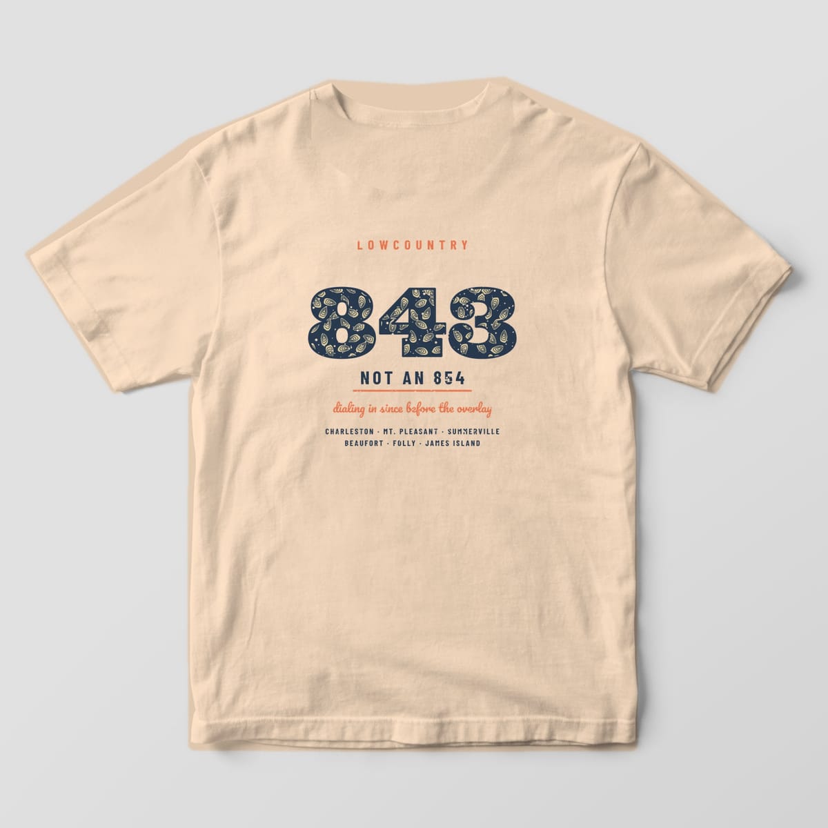 Back of an ivory Comfort Colors 1717 tee with large navy 843 numerals filled with oyster shells