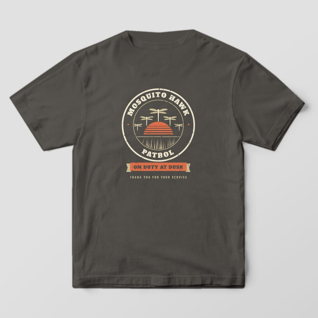 Back of a pepper Comfort Colors 1717 tee with a cream patrol badge, dragonflies and coral sunset