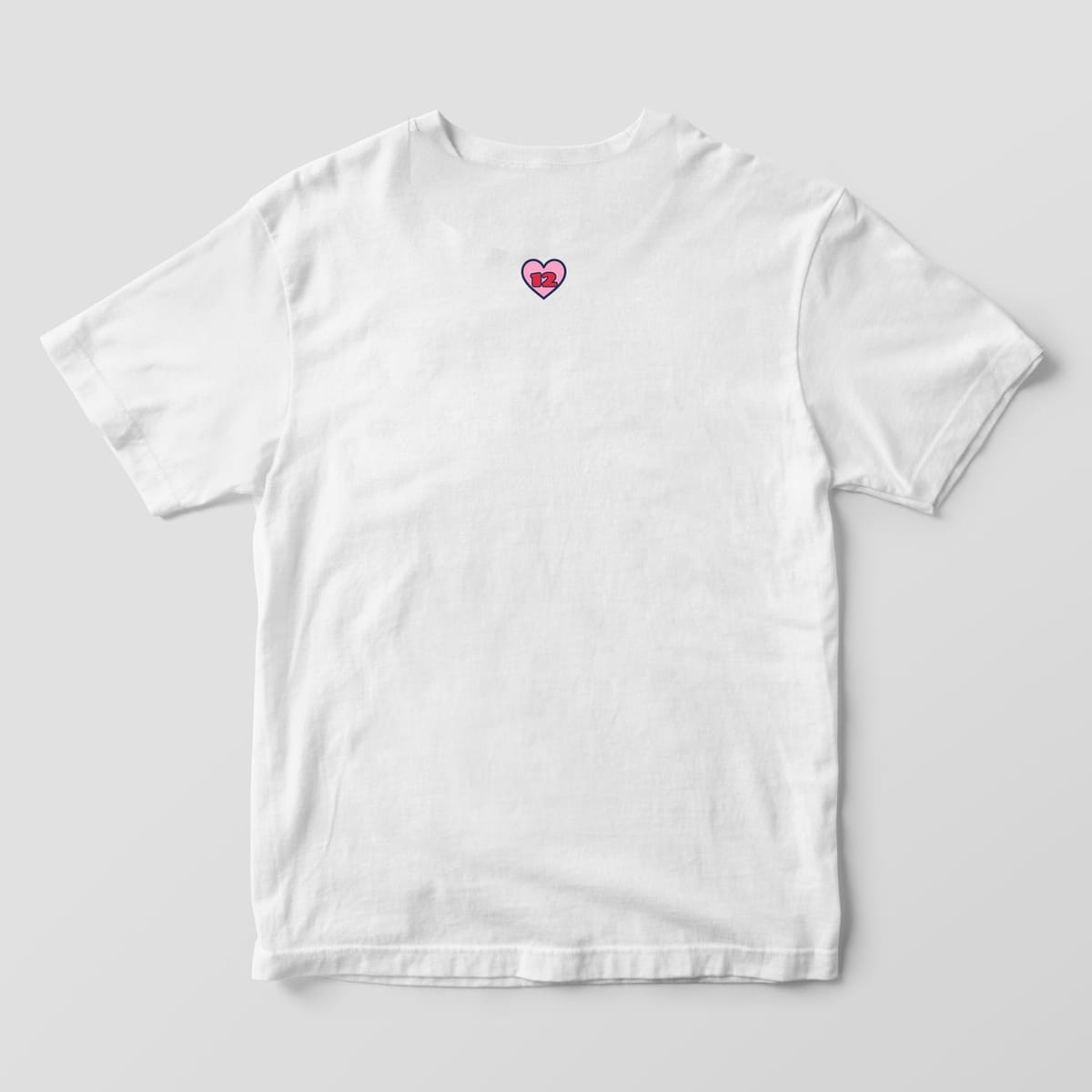 Back of a white Comfort Colors 1717 tee with a small pink 12 heart below the collar
