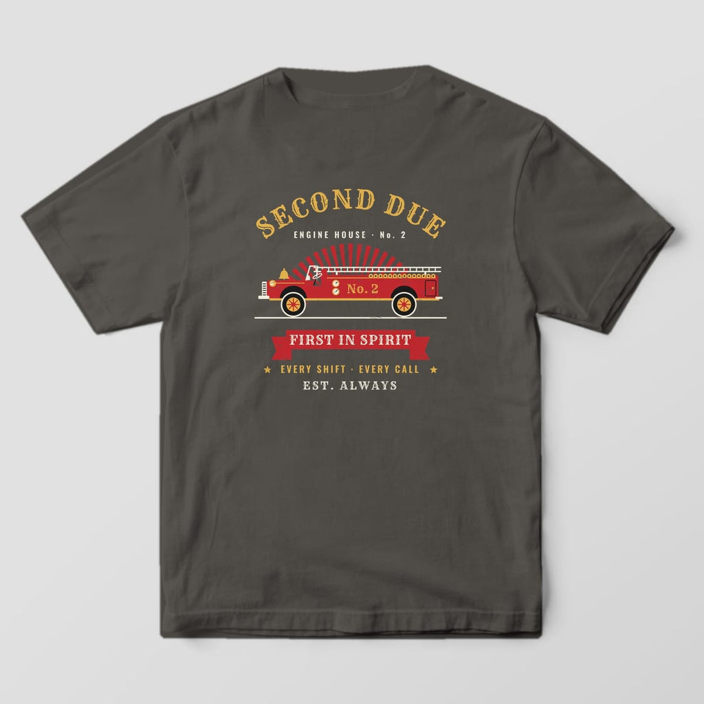 Back of a pepper Comfort Colors tee printed with a red vintage fire engine, gold Second Due lettering and a First In Spirit banner
