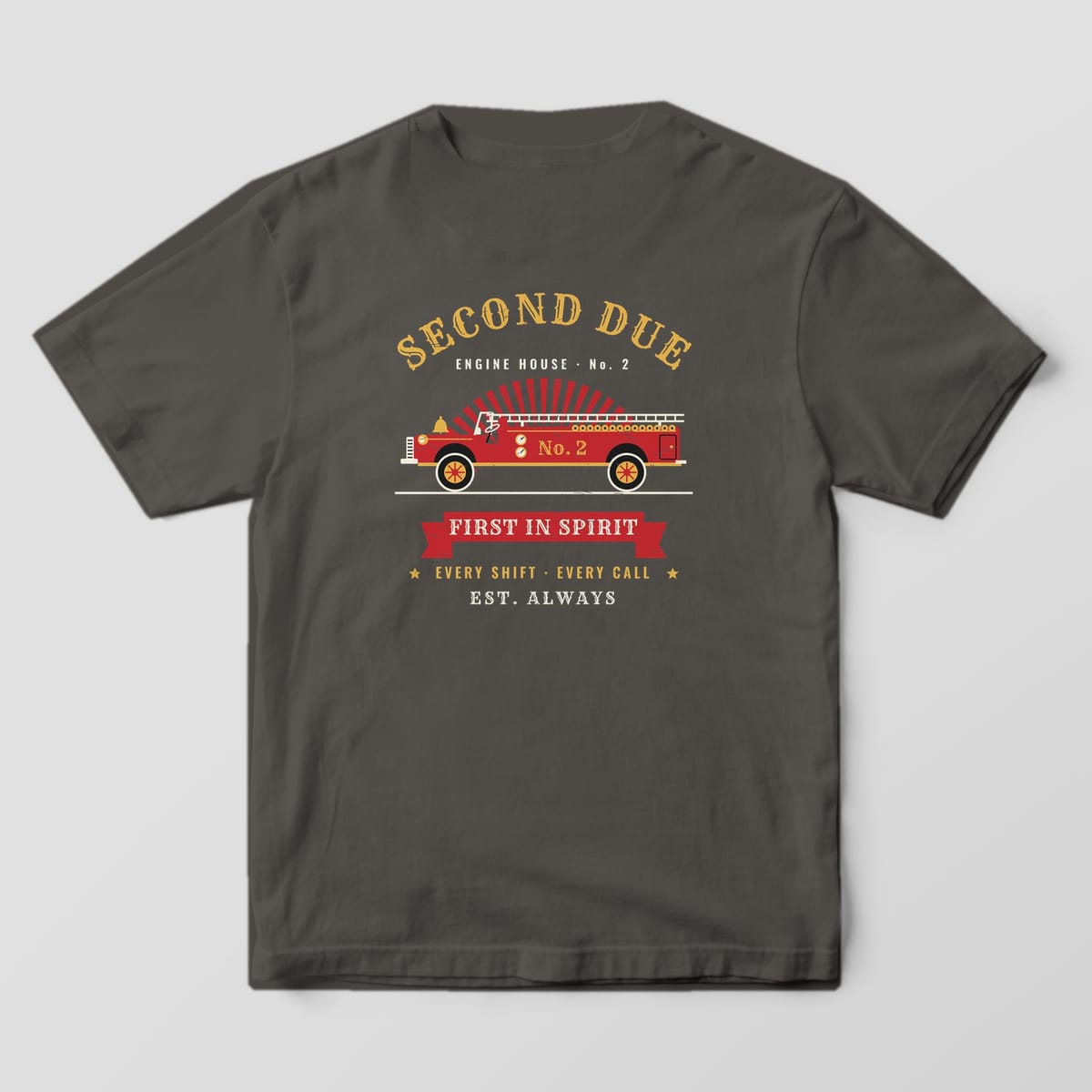 Back of a pepper Comfort Colors tee printed with a red vintage fire engine, gold Second Due lettering and a First In Spirit banner