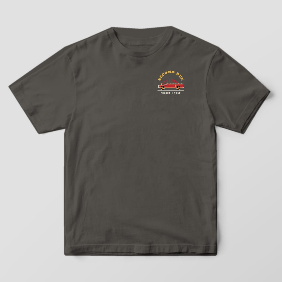 Front of a pepper Comfort Colors tee with a small Second Due engine badge on the left chest