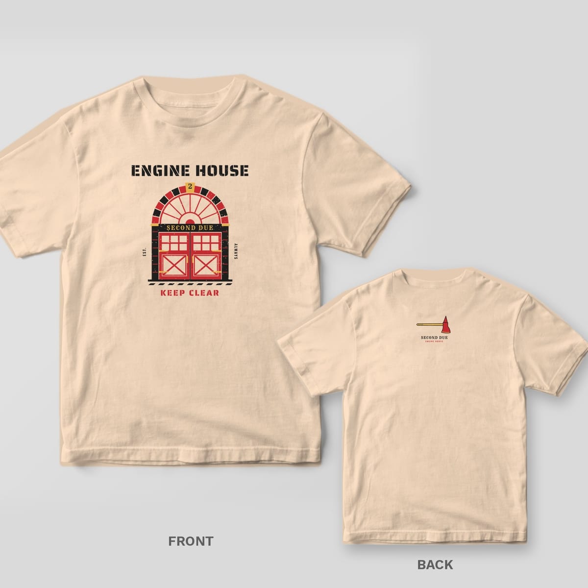 Ivory tee with a small fire axe and Second Due text on the upper back, and a large Engine House fire station door print on the front