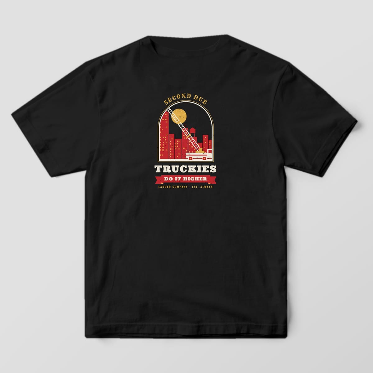 Back of a black Comfort Colors tee with an aerial ladder truck against a city skyline and moon, with Truckies Do It Higher