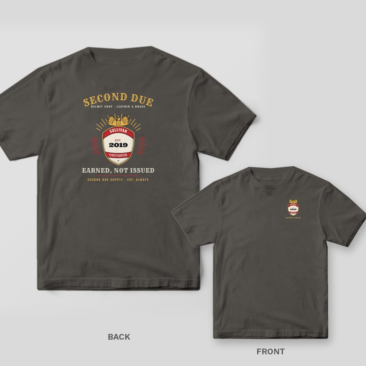 Charcoal tee with a personalized red, gold and cream helmet shield showing SULLIVAN and EST. 2019 on the back, matching small shield on the front chest