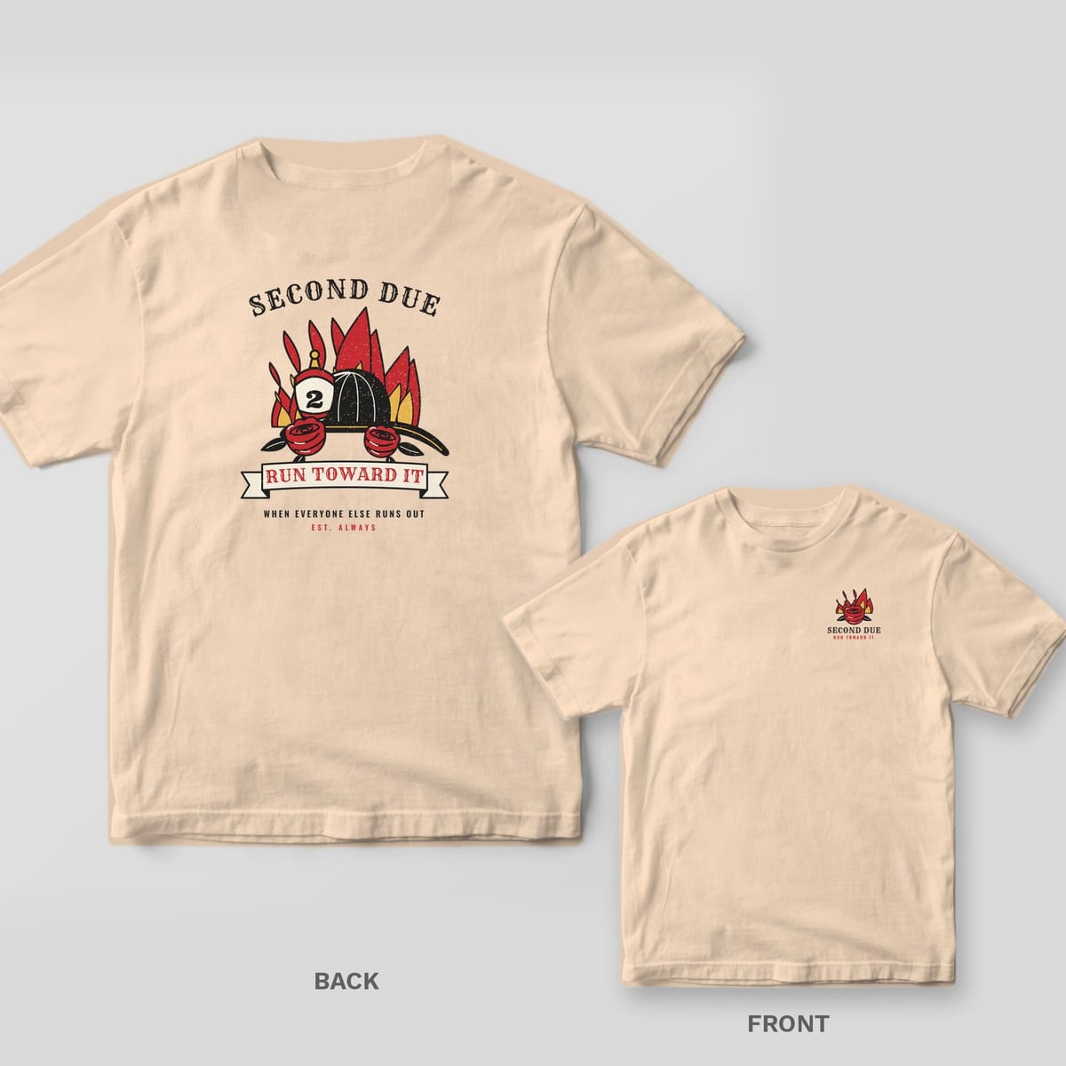Cream tee with a tattoo flash fire helmet, red roses, flames and a Run Toward It banner on the back, small flaming rose on the front chest