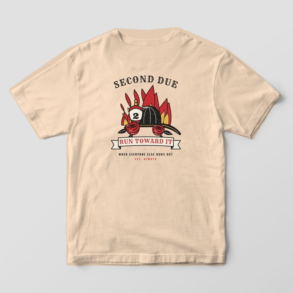 Back of an ivory Comfort Colors tee with a black fire helmet, red roses and flames in traditional tattoo style with a Run Toward It banner