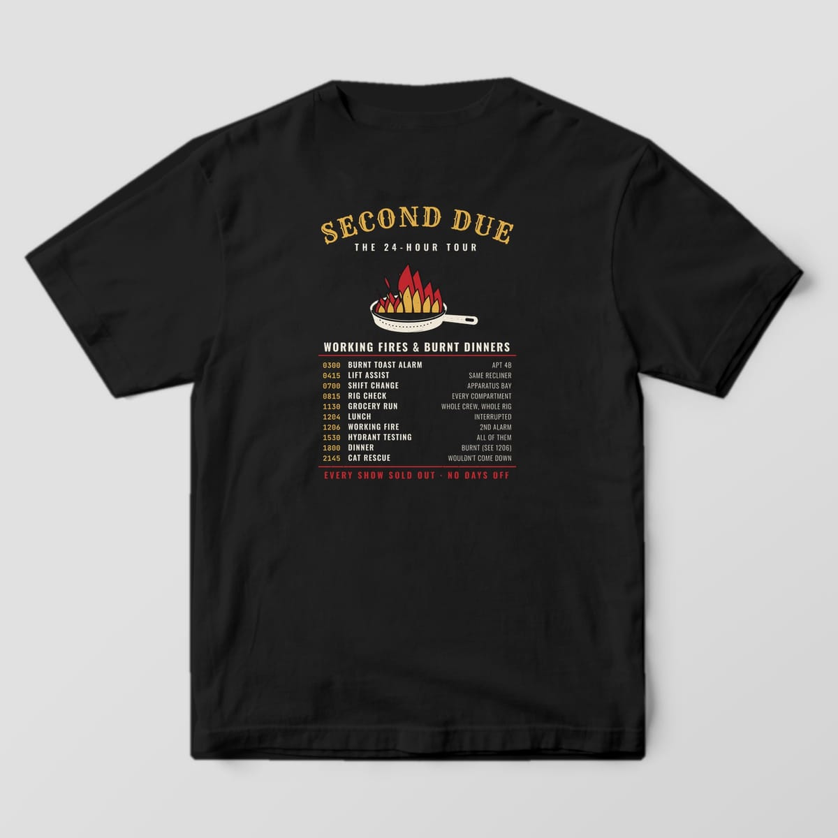 Back of a black Comfort Colors tee with a flaming skillet, Working Fires & Burnt Dinners and a list of shift times and calls