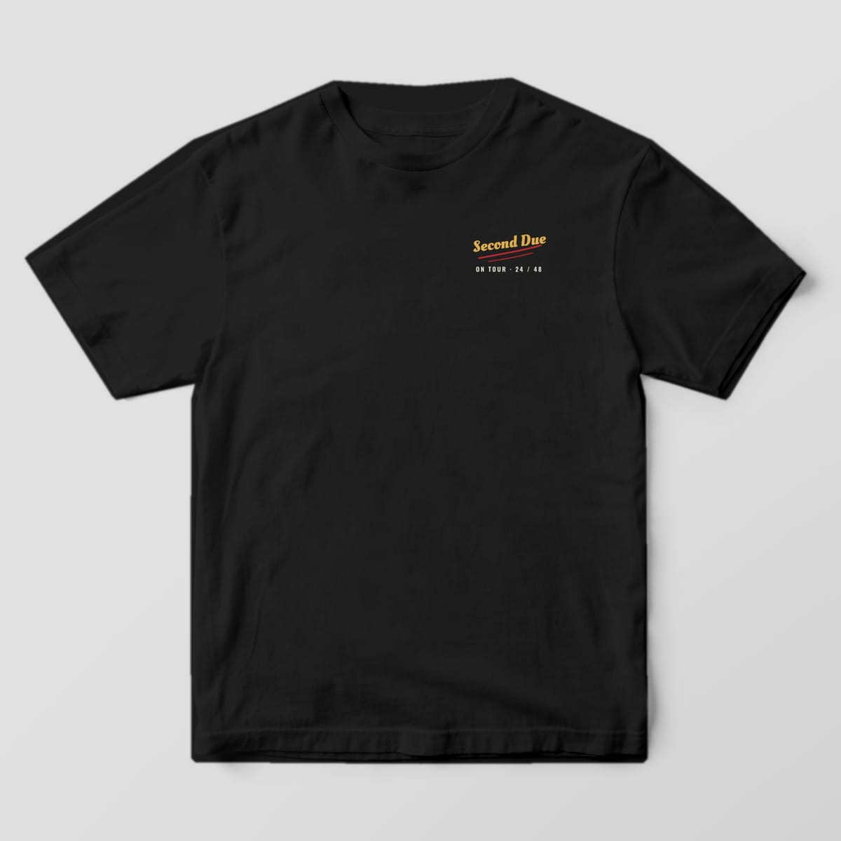 Front of a black Comfort Colors tee with Second Due in gold script and a red underline on the left chest