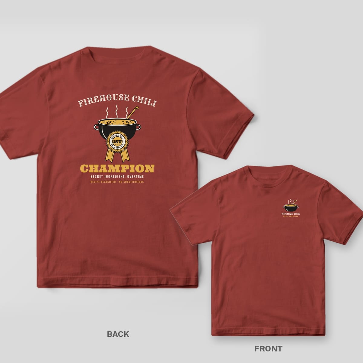 Brick red tee with a steaming chili pot, gold first place rosette and Champion on the back, small chili pot on the front chest