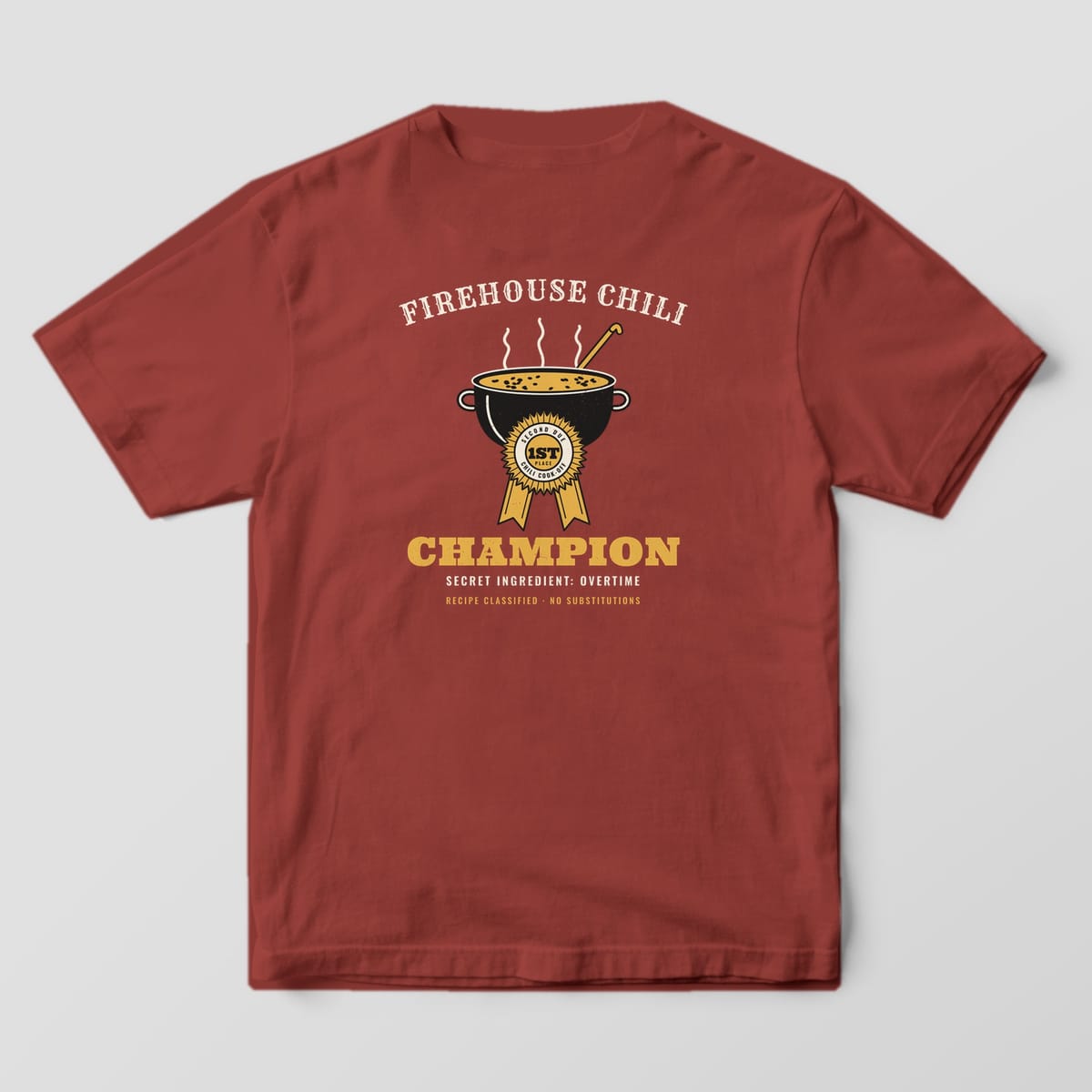 Back of a brick Comfort Colors tee with a black cast-iron chili pot, gold prize ribbon and Firehouse Chili Champion