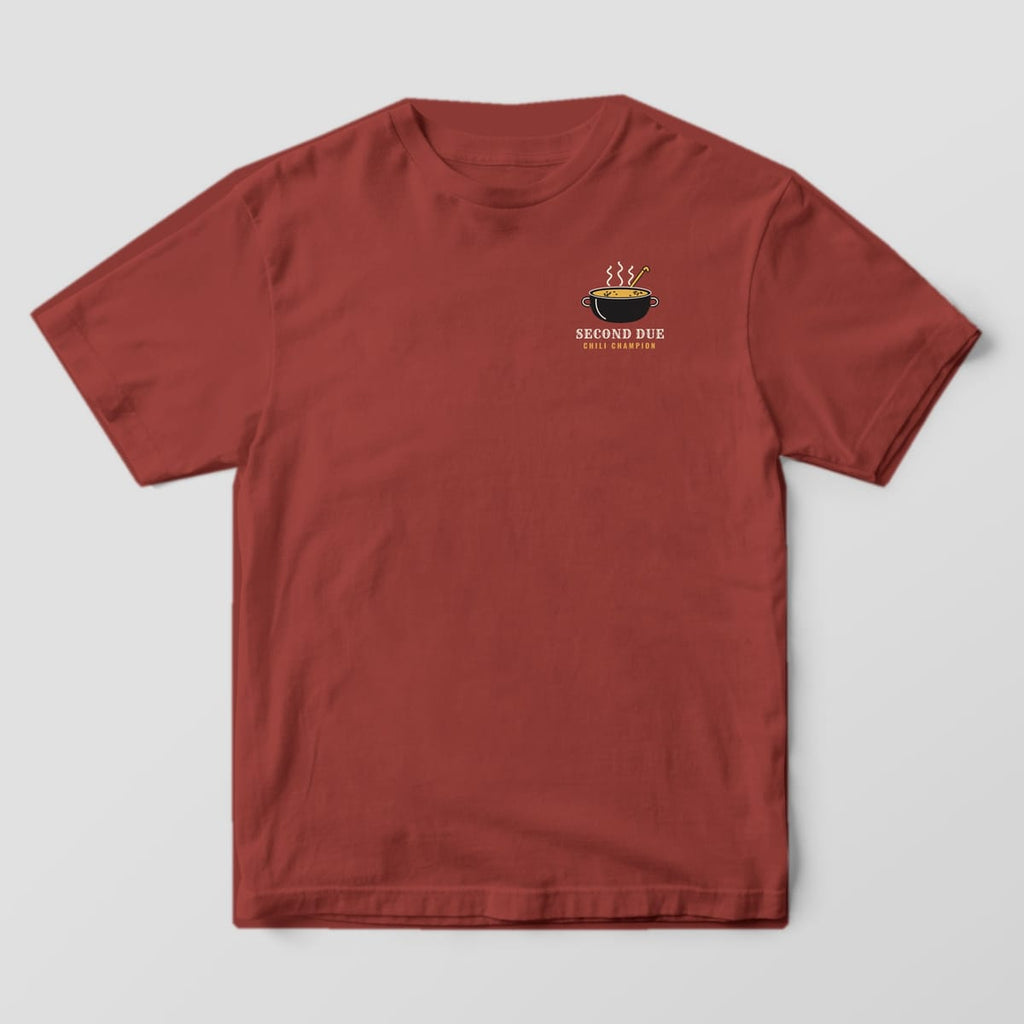 Front of a brick Comfort Colors tee with a small steaming chili pot and Second Due Chili Champion on the left chest