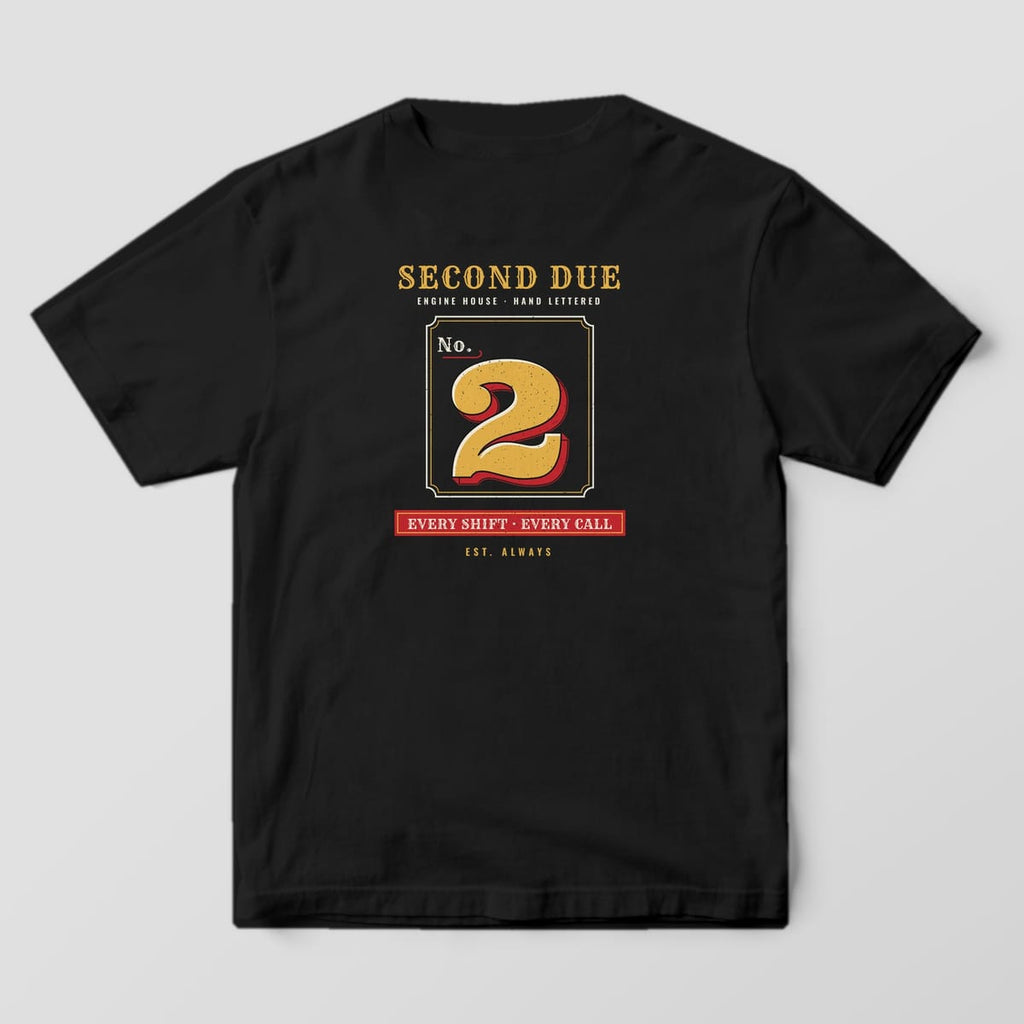 Back of a black Comfort Colors tee with a gold leaf No. 2 with red shading, Second Due lettering and an Every Shift Every Call plaque