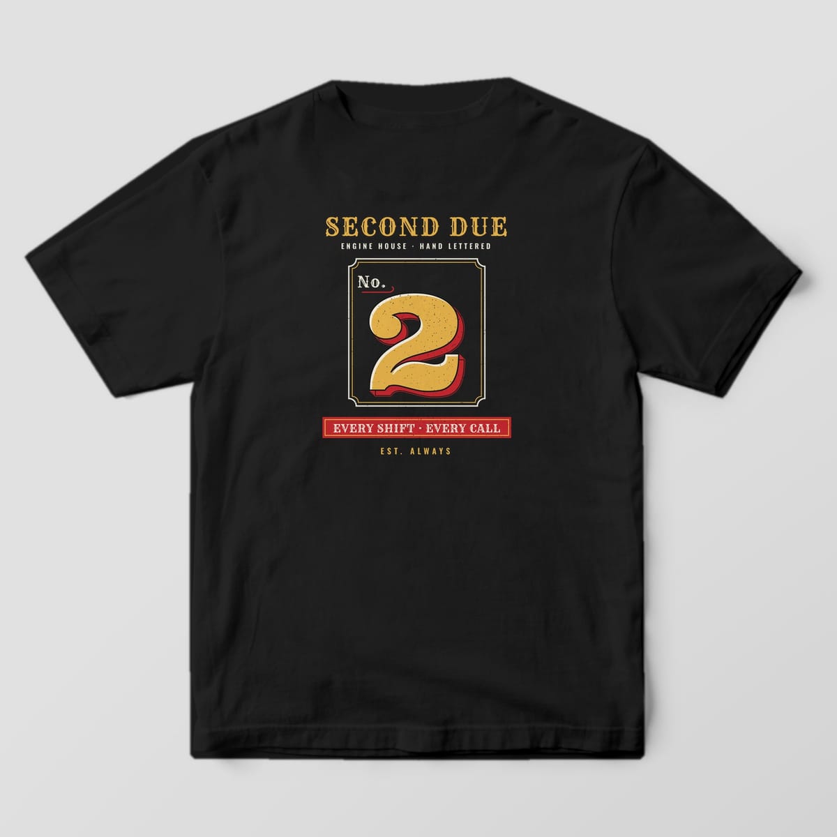 Back of a black Comfort Colors tee with a gold leaf No. 2 with red shading, Second Due lettering and an Every Shift Every Call plaque