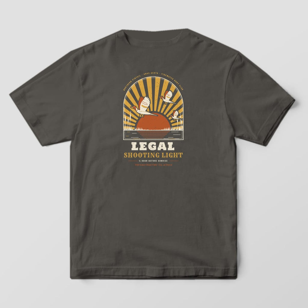 Back print on a Pepper Comfort Colors 1717 tee: Arched window of gold sunrays over a rust rising sun, three drake pintails landing over marsh grass and cattails, with "Legal Shooting Light" and "½ Hour Before Sunrise" below
