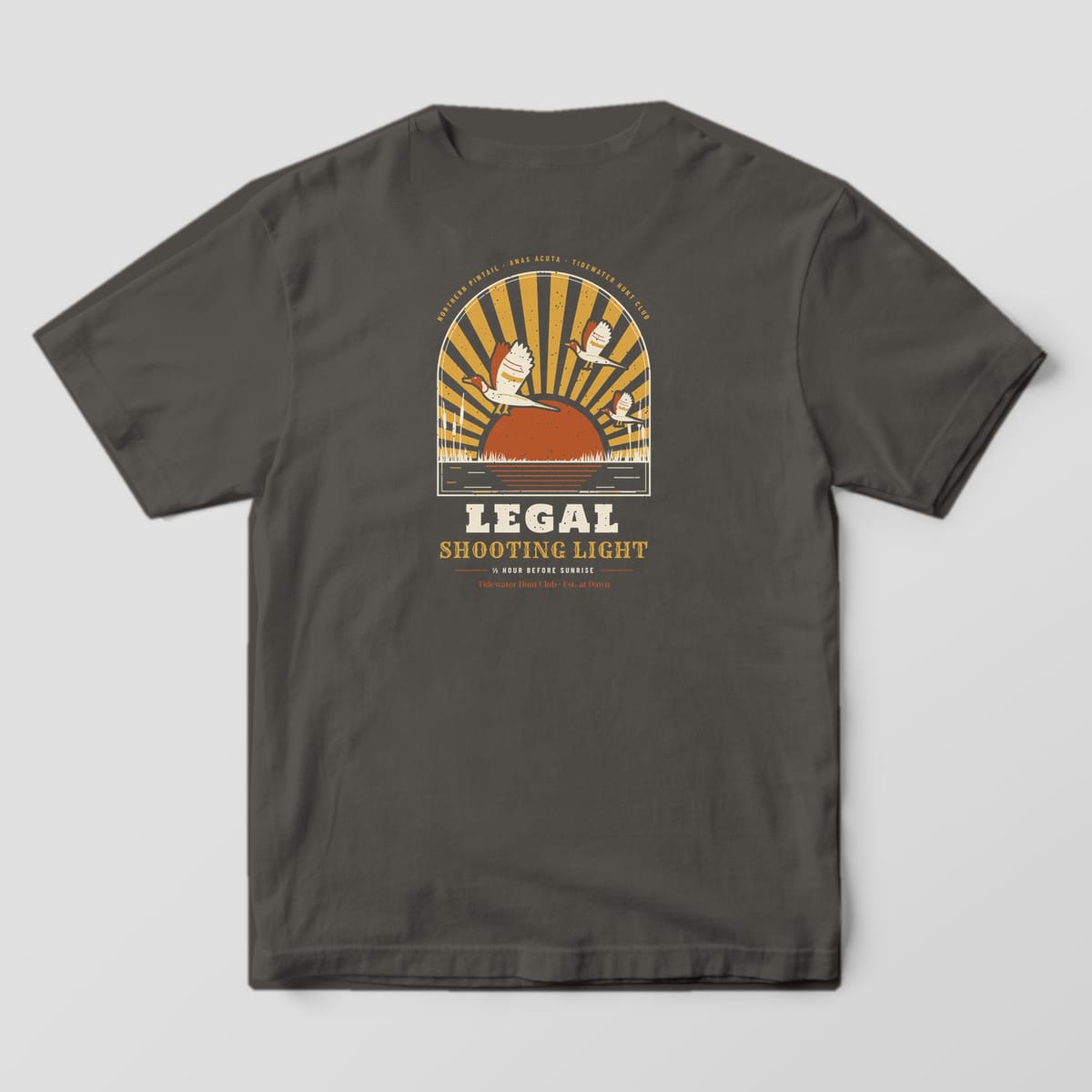 Back print on a Pepper Comfort Colors 1717 tee: Arched window of gold sunrays over a rust rising sun, three drake pintails landing over marsh grass and cattails, with "Legal Shooting Light" and "½ Hour Before Sunrise" below