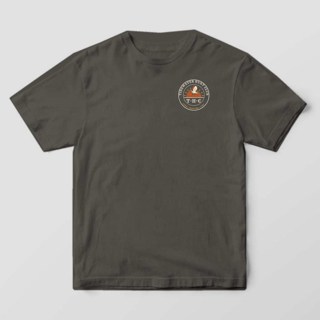 Front of the Pepper Comfort Colors 1717 tee showing the left-chest print: Left-chest round club seal with "Tidewater Hunt Club" arched on top, a pintail over a rising sun, "T·H·C" monogram and "Legal Shooting Light" on the rim