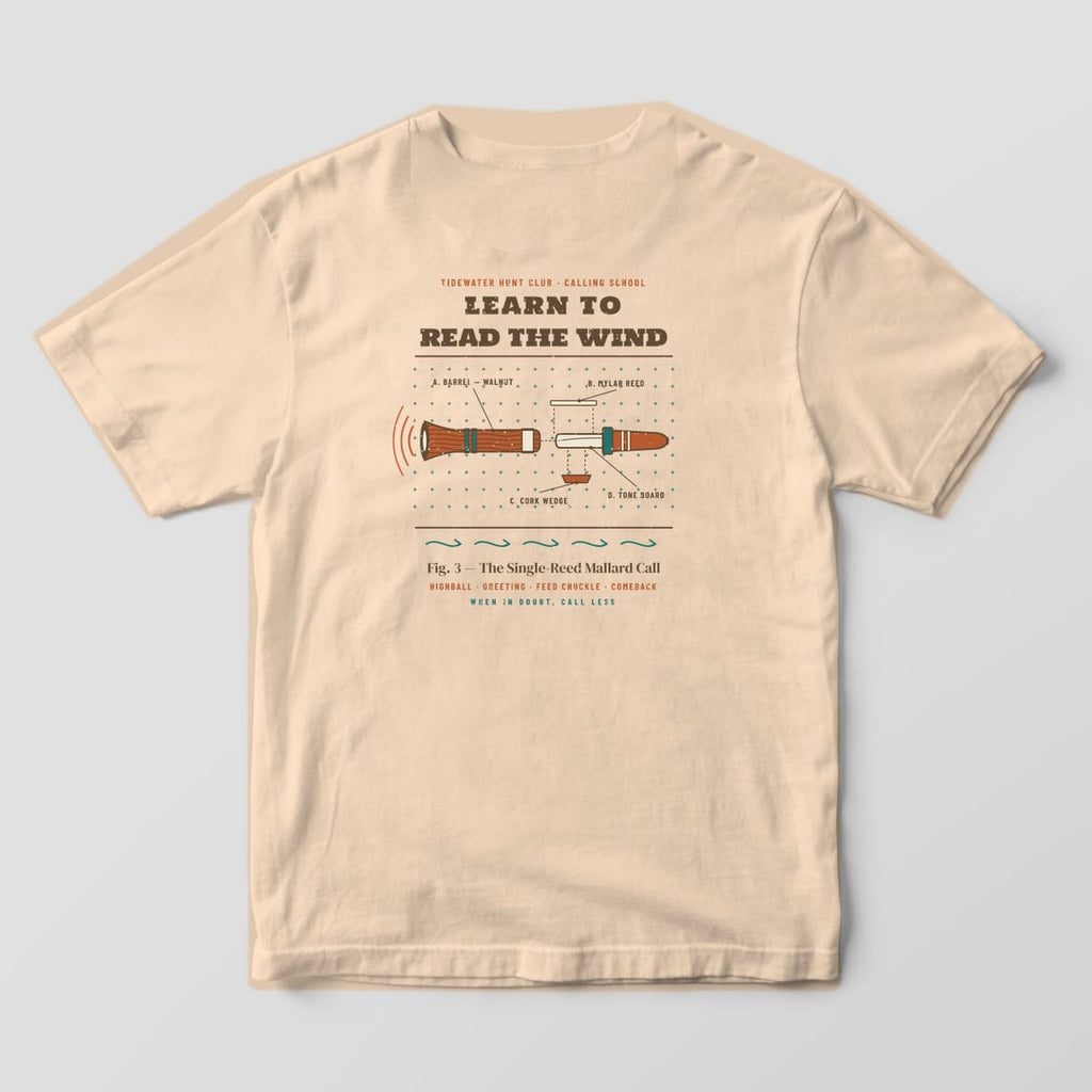 Back print on a Ivory Comfort Colors 1717 tee: "Learn to Read the Wind" over an exploded parts diagram of a single-reed mallard call (barrel, reed, cork wedge, tone board), captioned "Fig. 3, The Single-Reed Mallard Call" with "When in...