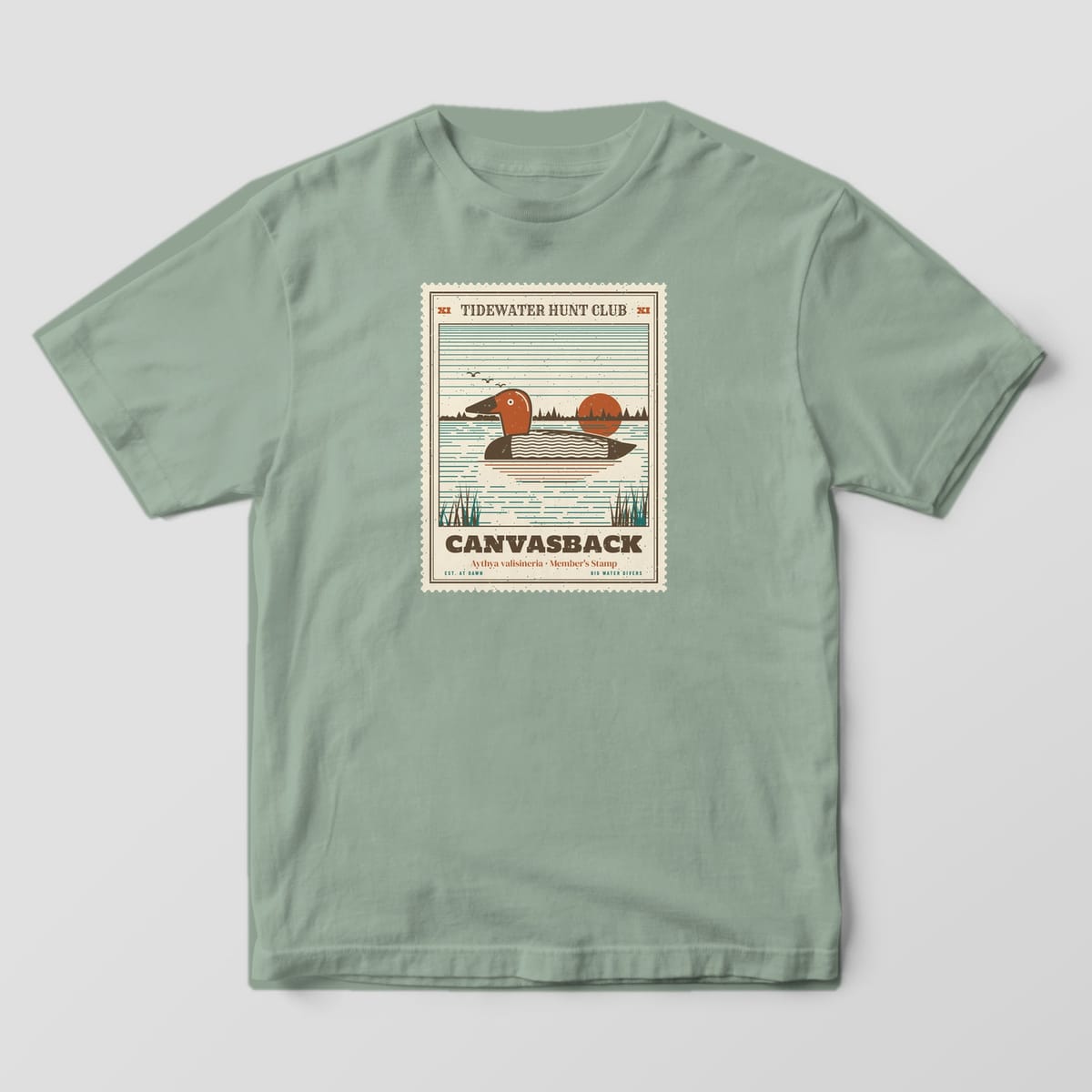 Front of the Bay Comfort Colors 1717 tee showing the full-front print: Full-front perforated stamp in bone with "Tidewater Hunt Club" header, an engraved-style canvasback drake on open water with a low sun and distant pines, and "Canvasback,...