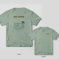 Back and front views of a sage green T-shirt with a heron eyeing duck decoys on the back and a small heron on the chest