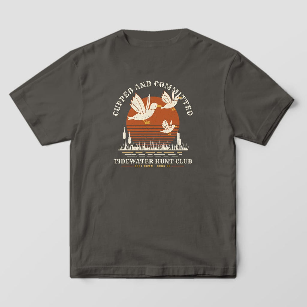 Back print on a Pepper Comfort Colors 1717 tee: "Cupped and Committed" arched over three mallards with feet down landing over cattails and a striped rust sun, with "Tidewater Hunt Club" and "Feet Down, Guns Up" below