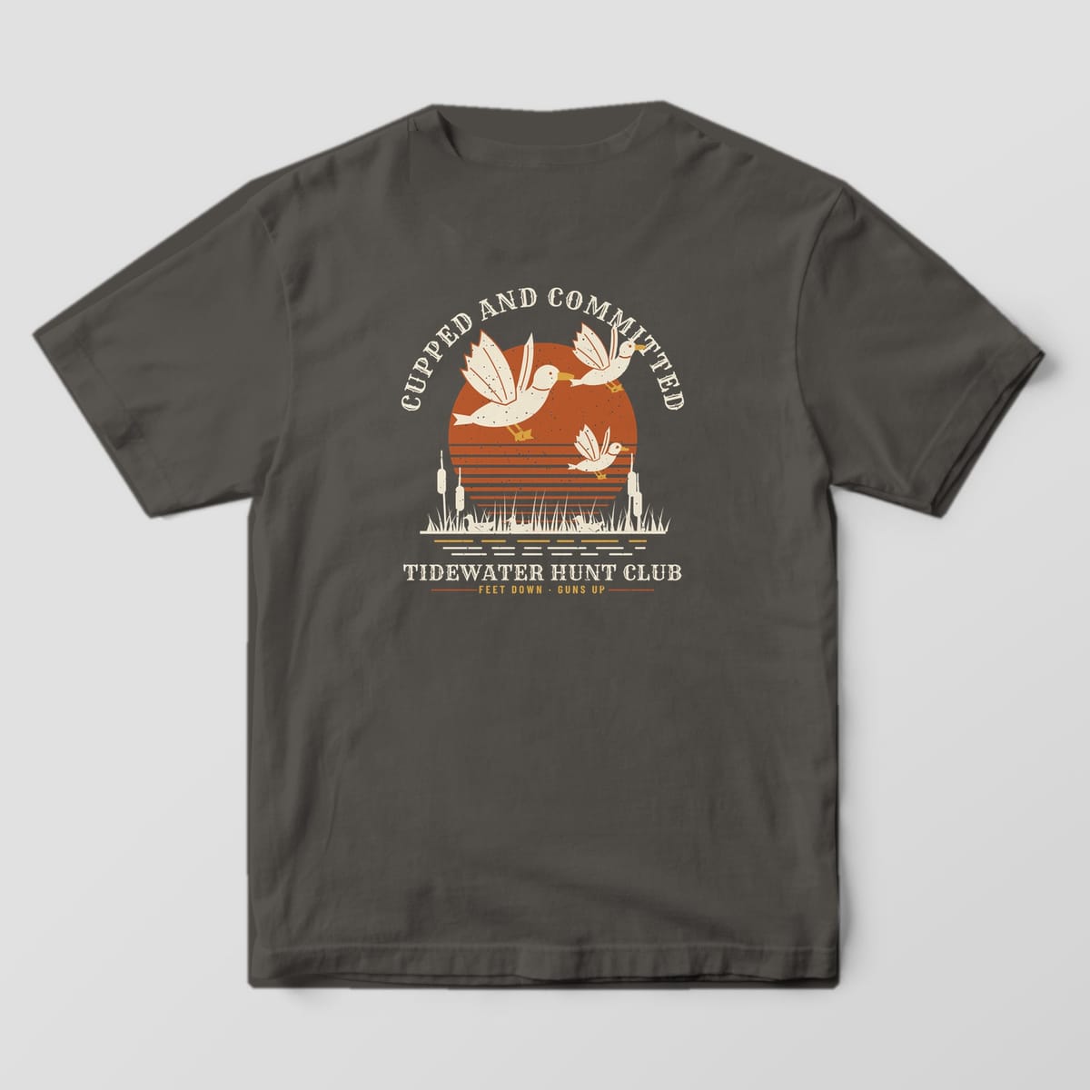 Back print on a Pepper Comfort Colors 1717 tee: "Cupped and Committed" arched over three mallards with feet down landing over cattails and a striped rust sun, with "Tidewater Hunt Club" and "Feet Down, Guns Up" below