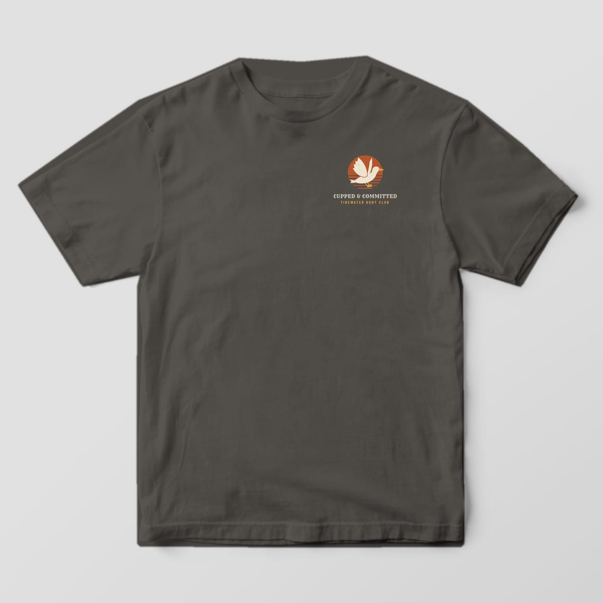 Front of the Pepper Comfort Colors 1717 tee showing the left-chest print: Left-chest mark with a cupped mallard over a small rust sun, "Cupped & Committed" and "Tidewater Hunt Club"