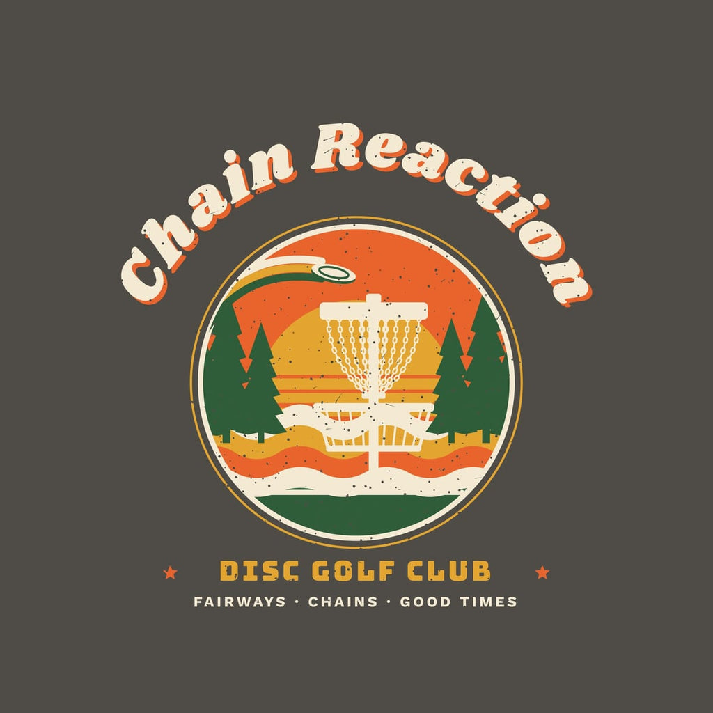 Close-up of the back print artwork: a round retro sunset badge with a disc golf basket and pines under arched Chain Reaction lettering, with retro speckled texture.