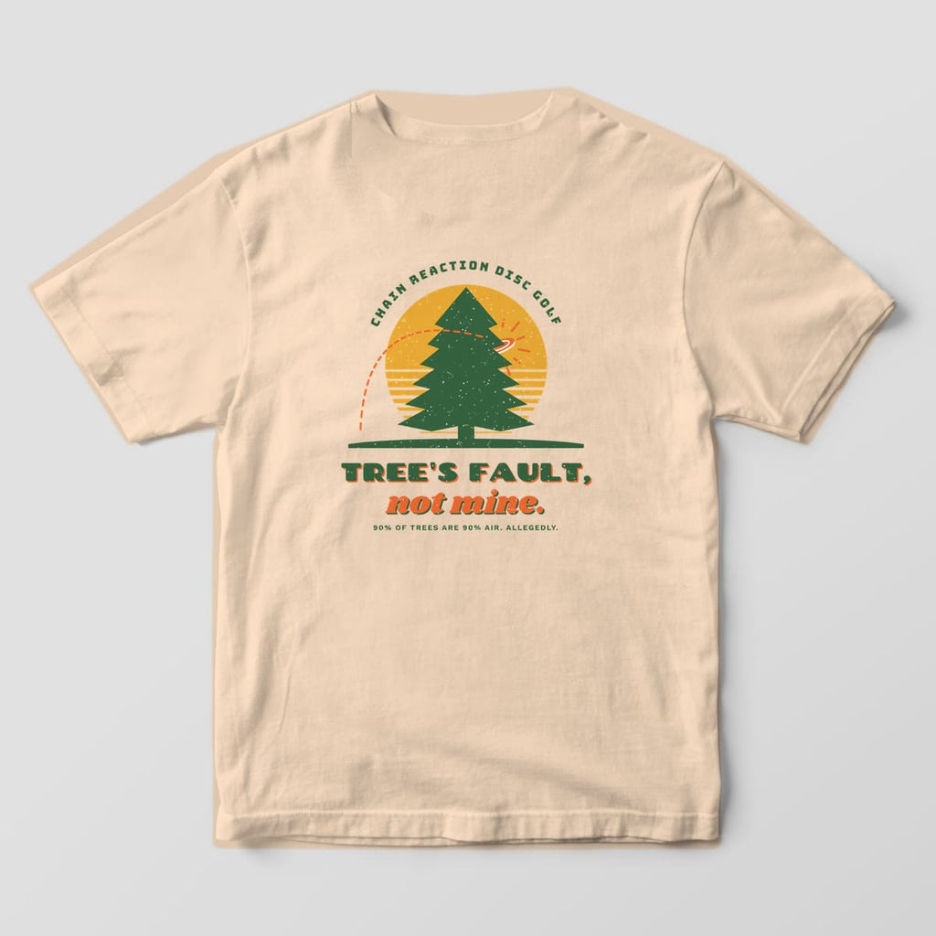 Back of an Ivory Comfort Colors 1717 tee printed with a forest-green pine against a mustard sun with a disc hitting it and the words Tree's Fault, not mine.