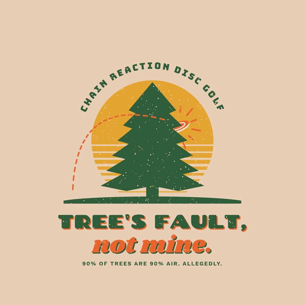 Close-up of the back print artwork: a forest-green pine against a mustard sun with a disc hitting it and the words Tree's Fault, not mine, with retro speckled texture.