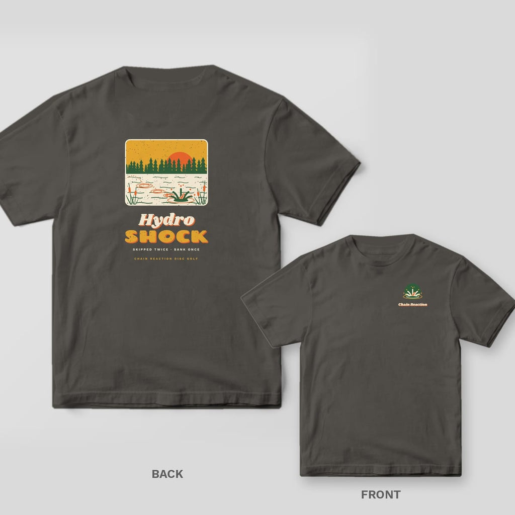 Pepper Comfort Colors tee shown back and front: a framed retro pond scene with pines, cattails and a disc skipping into the water above the words Hydro Shock on the back and a small left-chest print.