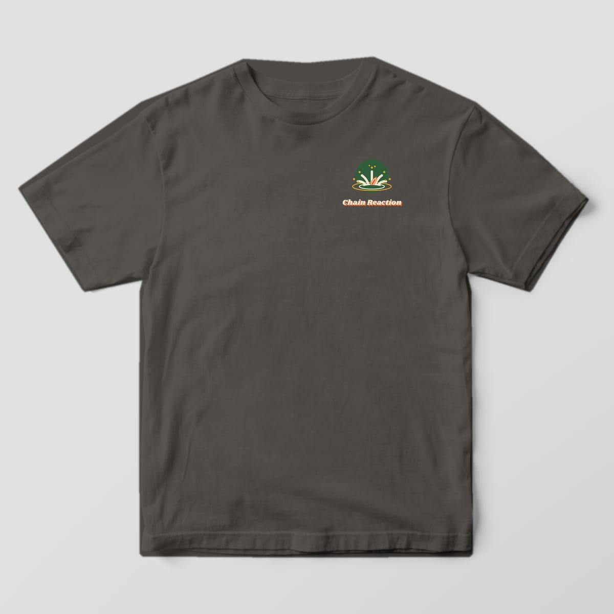 Front of a Pepper Comfort Colors 1717 tee with a small water splash icon with a sinking disc and the Chain Reaction wordmark on the left chest.