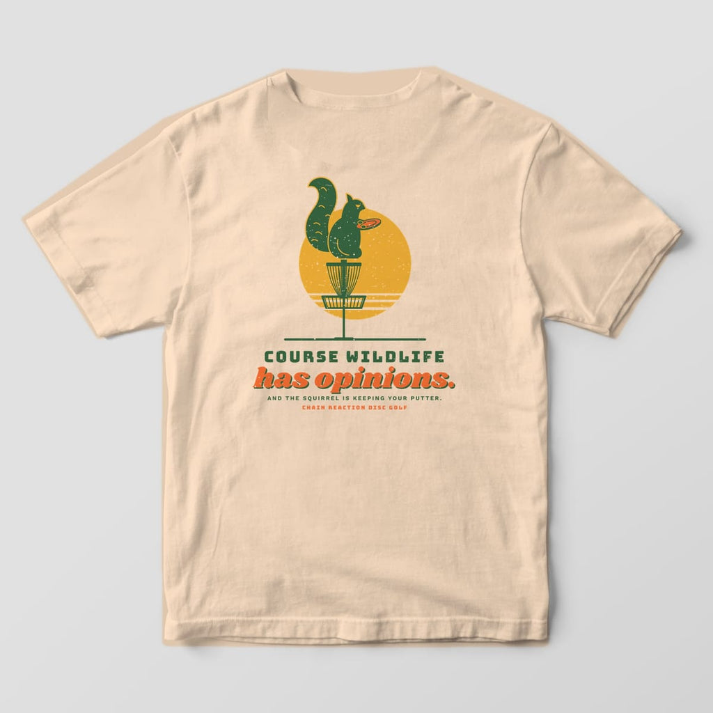 Back of an ivory Comfort Colors t-shirt with a squirrel sitting on a disc golf basket and the text Course Wildlife has opinions
