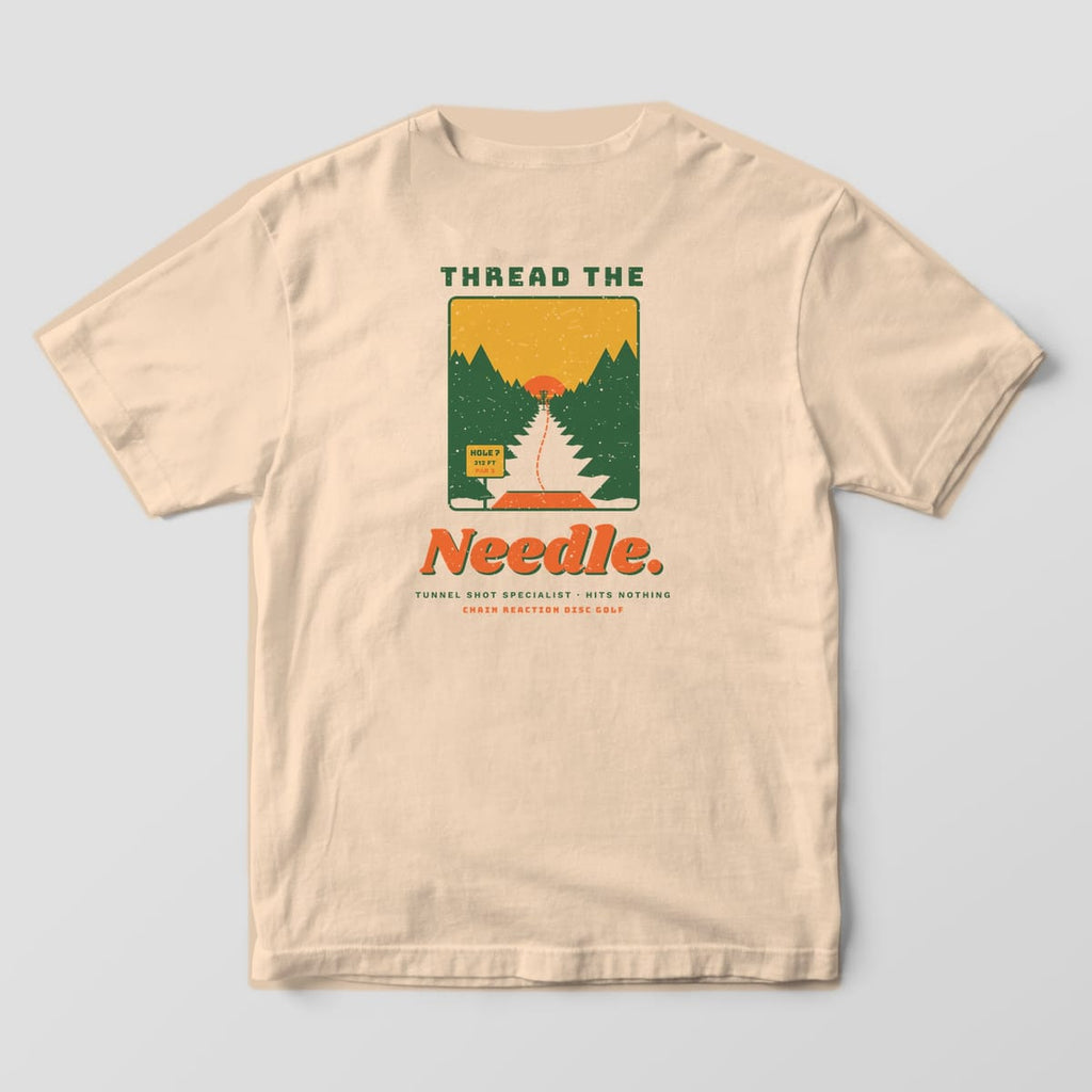 Back of an ivory Comfort Colors t-shirt with a tunnel shot scene through pine trees and the words Thread the Needle