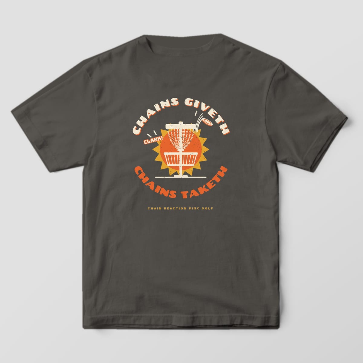 Back of a Pepper Comfort Colors 1717 tee printed with a cream disc golf basket on an orange sunburst with a disc bouncing out and the words Chains Giveth, Chains Taketh.