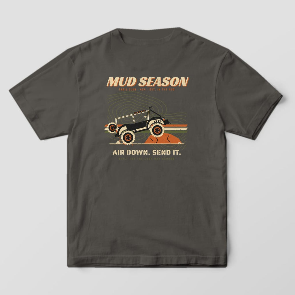 Back of a Pepper Comfort Colors 1717 tee printed with a Mud Season wordmark, lifted 4x4 on a rock ledge over topo lines and racing stripes, Air Down Send It text