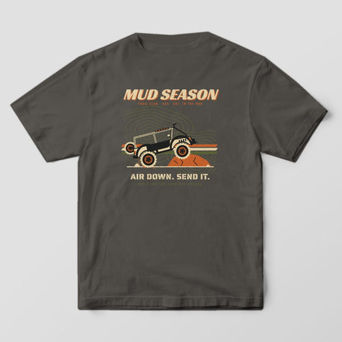 Back of a Pepper Comfort Colors 1717 tee printed with a Mud Season wordmark, lifted 4x4 on a rock ledge over topo lines and racing stripes, Air Down Send It text