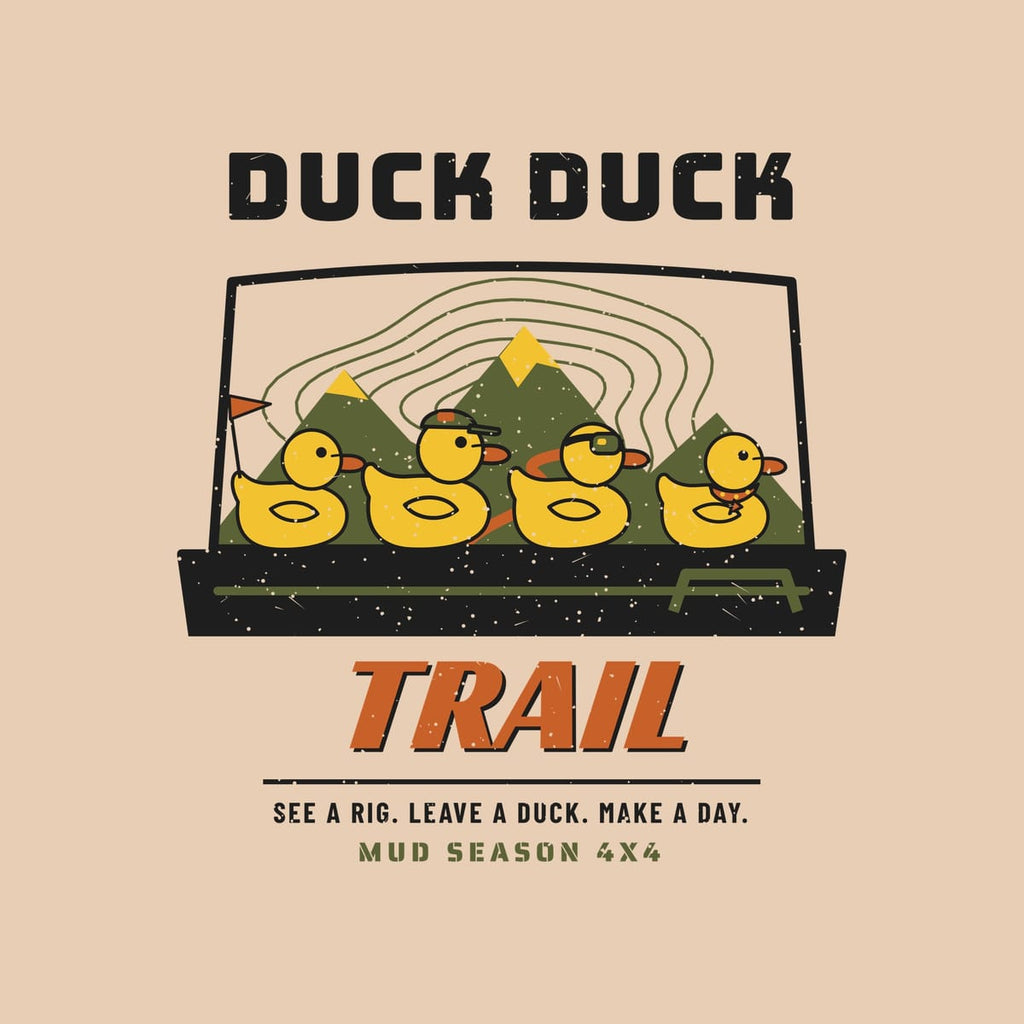 Close-up of the back print artwork, four rubber ducks on a dashboard with mountains behind and Duck Duck Trail text, on an ivory background