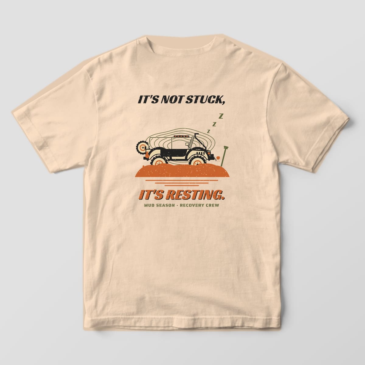 Back of an Ivory Comfort Colors 1717 tee printed with a trail rig sunk in orange mud with sleeping Z's and It's Not Stuck, It's Resting text