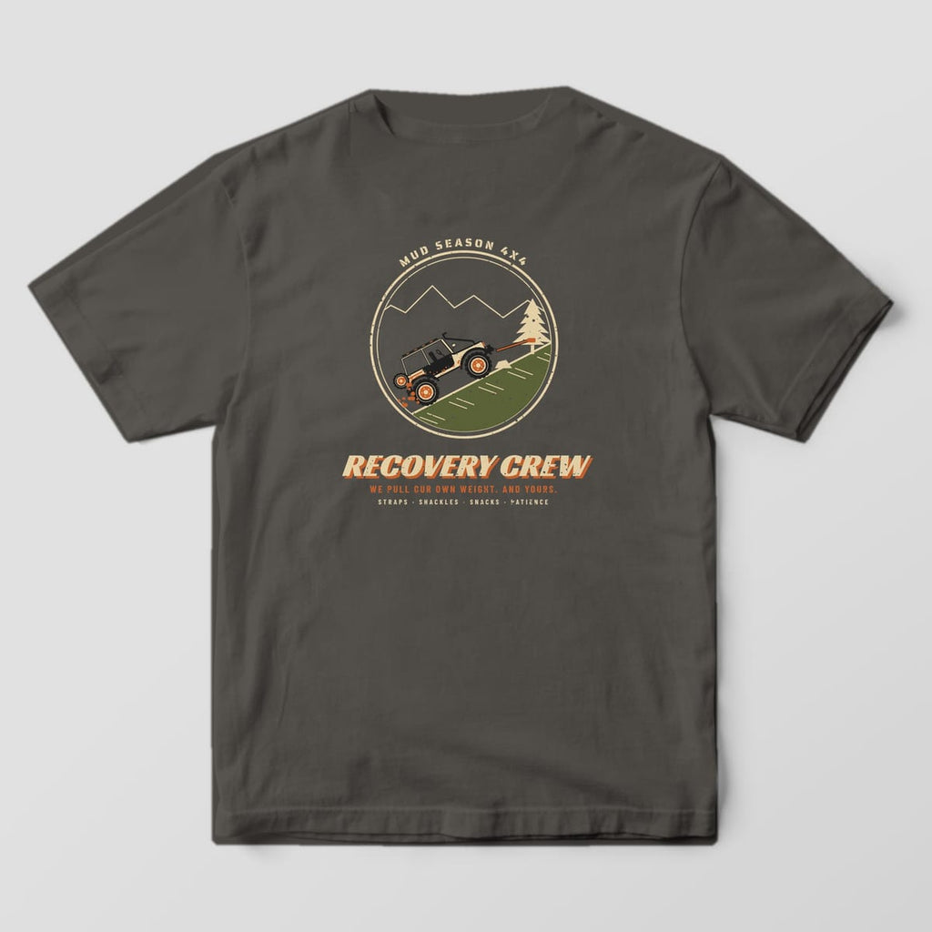 Back of a Pepper Comfort Colors 1717 tee printed with a circle badge of a trail rig winching up a hill to a pine tree with Recovery Crew text