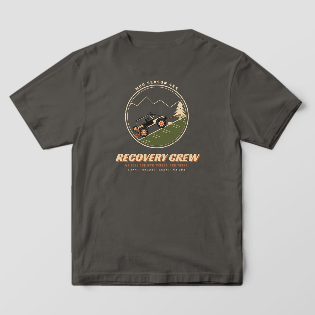Back of a Pepper Comfort Colors 1717 tee printed with a circle badge of a trail rig winching up a hill to a pine tree with Recovery Crew text