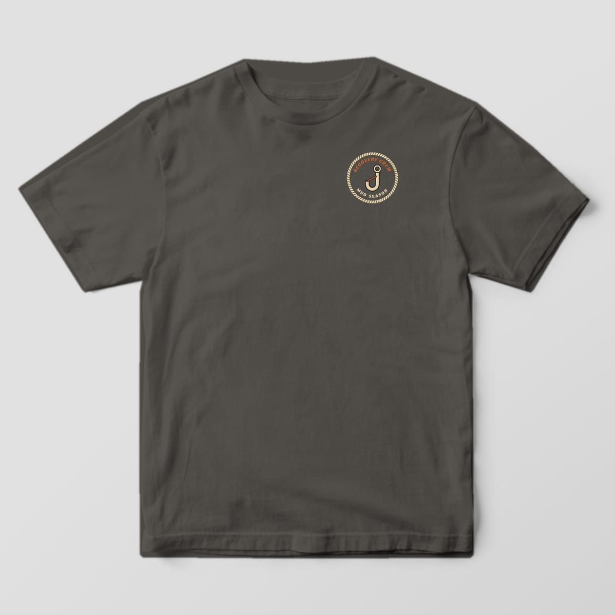 Front of a Pepper Comfort Colors 1717 tee with a small left-chest winch hook inside a rope ring reading Recovery Crew