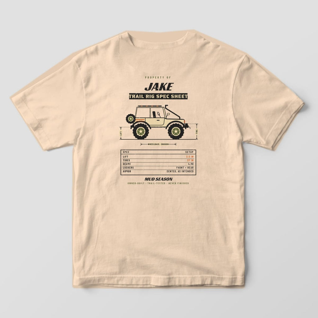 Back of an Ivory Comfort Colors 1717 tee printed with a custom name trail rig spec sheet with a lifted 4x4 side view and spec table